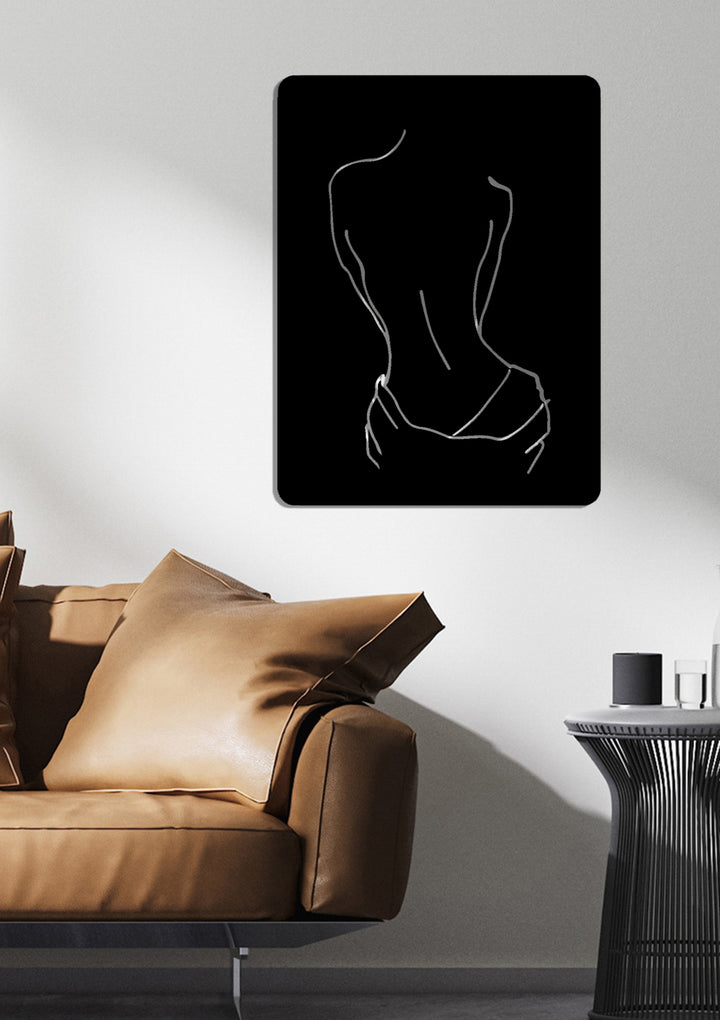 Minimalistische metalen muurdecoratie met line art van een vrouwenrug. Een elegante eyecatcher voor een moderne woonkamer.