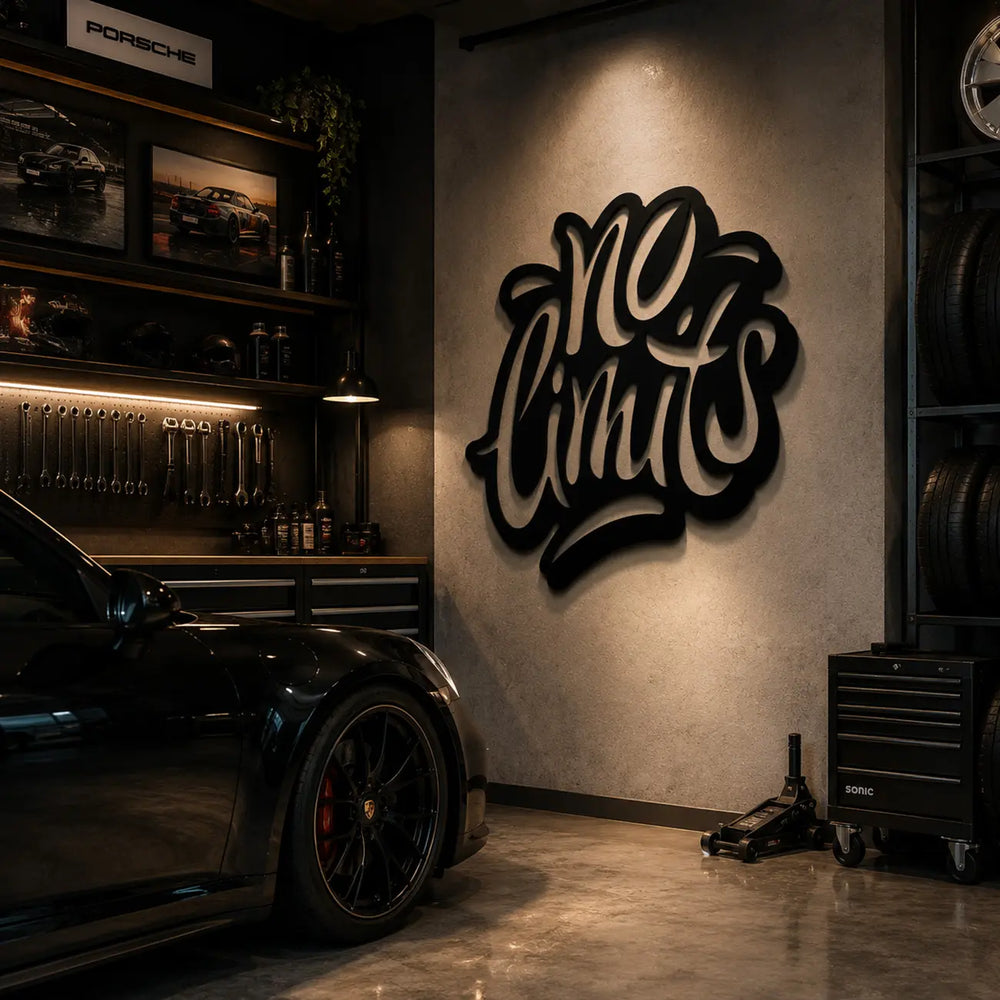 Zwarte metalen muurdecoratie met No Limits tekst, hangend aan een bakstenen muur in een stoere mancave of garage.