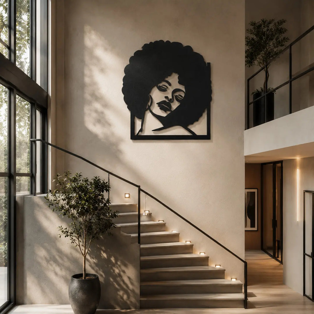 Indrukwekkende afro vrouw metalen wanddecoratie als prachtig statement piece boven de trap in een luxe huis. Impressive afro woman metal wall decor as a beautiful statement piece above the stairs in a luxury home.